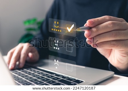 Man hand using a pen pressing on vitual 5 star rating feedback icon.Customer service satisfaction survey concept, business concept, quality and performance of services.