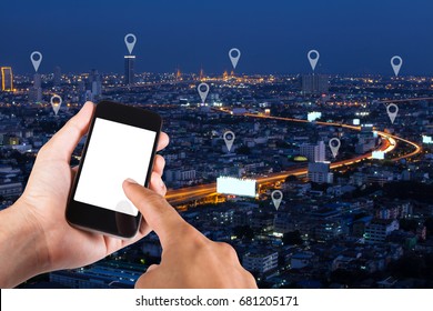 Man Hand Using Smartphone Searching Location  On Map Pin On Top View City Scape In Bangkok, Thailand.