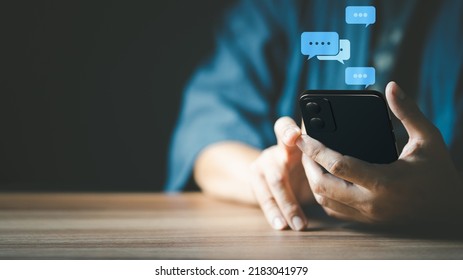 Man hand using smartphone typing live chat chatting on application communication digital web and social network concept. Social media application chat box. - Shutterstock ID 2183041979