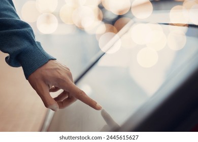 Man hand using touchscreen display of kiosk, close up view of male finger touching screen. Navigation and  journey  digital technology  