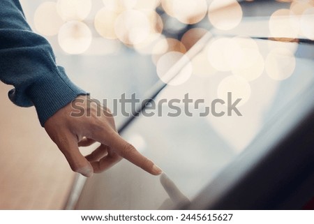 Man hand using touchscreen display of kiosk, close up view of male finger touching screen. Navigation and  journey  digital technology  