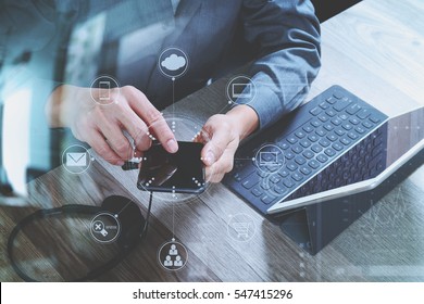 man hand using VOIP headset with digital tablet computer docking keyboard,smart phone,concept communication, it support, call center and customer service help desk,virtual interface icons screen