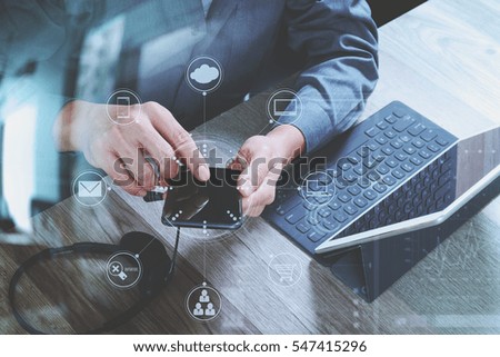 man hand using VOIP headset with digital tablet computer docking keyboard,smart phone,concept communication, it support, call center and customer service help desk,virtual interface icons screen