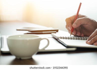 Man Hand Using Writing Pencil Memo On Notebook Paper Or Letter, Diary On Table Desk Office. Workplace For Student, Writer With Copy Space. Business Working And Learning Education Concept.