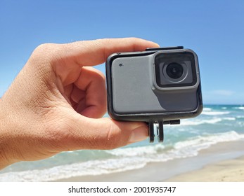 Man hand while holding action water resistent camera before filming sport session,tech devices