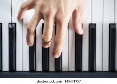 Man Hand While Playing A Piano Overhead Shot