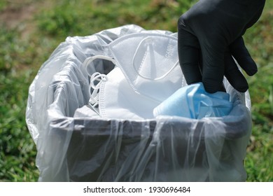 Man Hand While Trash Protective Mask On Separate Garbage Bin,covid19 Medical Disposal Waste,