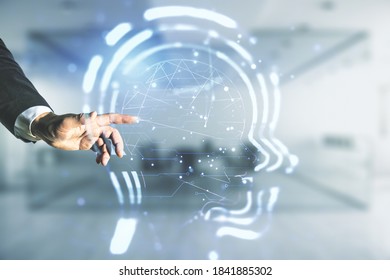 Man hand working with abstract virtual artificial Intelligence interface with human head hologram on blurred office background. Multiexposure - Shutterstock ID 1841885302