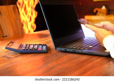 Man Hand Working On Laptop Computer On Table And Using Smartphone Home Quarantine New Normal Technology Business Concept