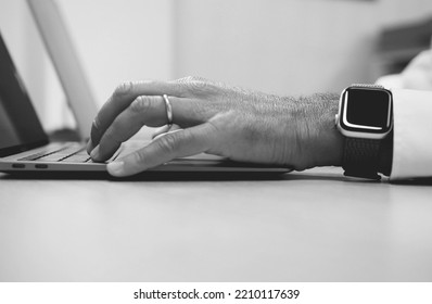 Man Hand Working On A Notebook Using Touchpad And Keyboard, Close Up. Slow Motion