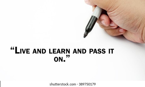 Man Hand writing "live and learn and pass it on" with black marker on visual screen. Isolated white background. Business, technology, internet concept. 