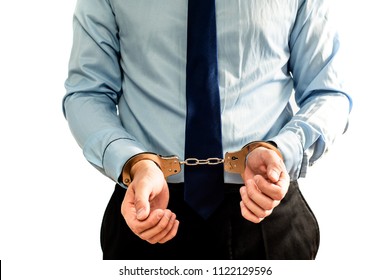 The man in handcuffs, handcuffed. Front view of a businessman dressed in a shirt with hands in handcuffs. Accusation of fiscal offense, financial crime. Financial pyramid.