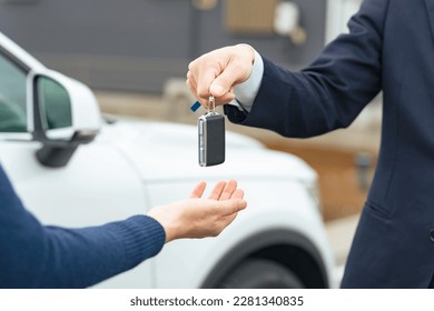 Man handing car smart key. Car rental. Car sharing.