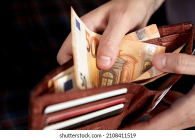 man handing wallet with euro
