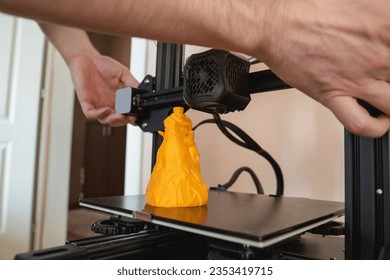 Man handling 3d printer, side view 3d printer with finished product
