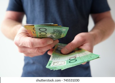 Man handling hundred and fifty Australian dollar bills. 
