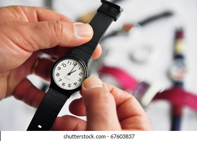 Man Hands Adjusting The Time On A Watch. Concept Photo Of Daylight Saving, Time, Alarm, Travel And Changing Time Zone. No People. Copy Space