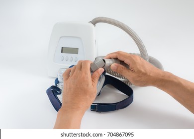 Man Hands Assembling Cpap Mask To Tube,isolated White Background,selective Focus.Cpap Components Assembly. 