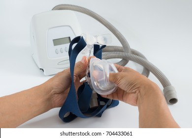 Man hands assembly softgel cushion to a mask frame ,isolated white background,selective focused.Cpap machine components. 