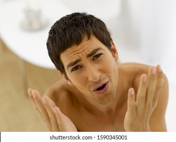 Man With Hands Up And Brow Furrowed