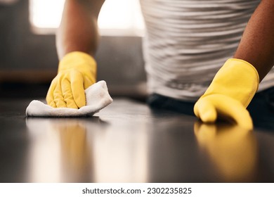 Man hands, cleaning gloves and wipe on a table with a wash cloth and housekeeping. Home, countertop and male person with disinfectant and scrub with washing in a apartment with maid and housekeeper - Powered by Shutterstock