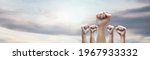 Man hands with clenched fist on sky background expressing freedom