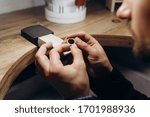 Man hands close up making silver jewelry top view preparation process dark. Working tools on the table. Handicraft people art concept. He makes silver ring