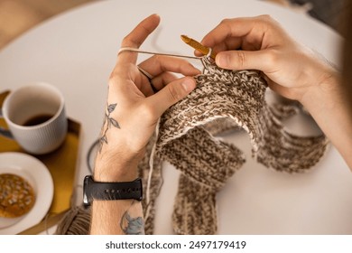 Man hands crochets handmade crocheting supplies assorted colored wool yarn hook knitting top view closeup. Feminine male enjoy handiwork handcrafted hobby create unique warm craft clothes workshop - Powered by Shutterstock