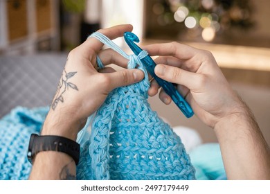 Man hands crochets handmade crocheting supplies assorted colored wool yarn hook knitting top view closeup. Feminine male enjoy handiwork handcrafted hobby create unique warm craft clothes workshop - Powered by Shutterstock