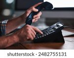 Man, hands and desk phone dialing for call, communication and administrator tech on table. Contact, typing and client update with receptionist, business extension and professional employee working