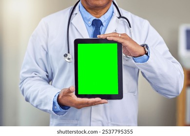 Man, hands and doctor with tablet for green screen, advertising or medical app at hospital. Closeup, male person or healthcare professional by technology display, mockup space or chromakey at clinic - Powered by Shutterstock