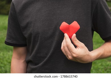 Man hands hold red heart. Health, love, World heart day and charity concept. Close up - Shutterstock ID 1788615740