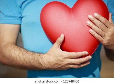 Man Hands Holding Big Red Heart