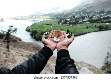 Man hands holding compass