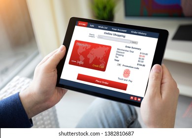 man hands holding computer tablet with app online shopping on the screen in the home room