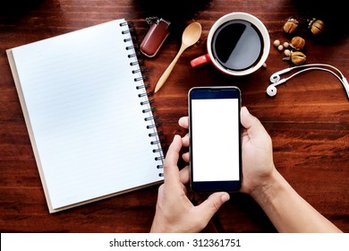 A Man Hands Holding Empty Screen Of Smartphone On Wood Desk Work. Top View Shot.