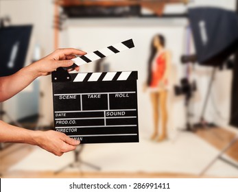 Man Hands Holding Film Clapper. Blur Film Studio On Background
