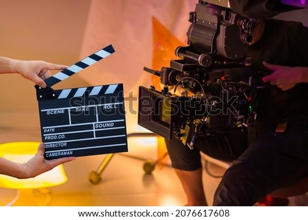Man hands holding movie clapper. Film director concept. Behind the scenes of movie shooting or video production and film crew team