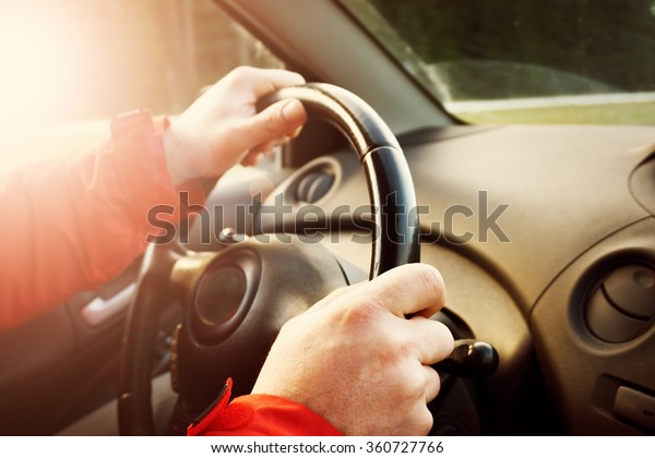 Man hands holding steering
wheel