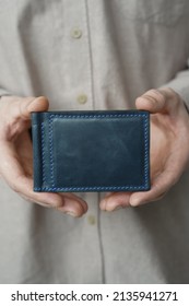 Man hands holding wallet. Handmade leather wallets. Leather craft.