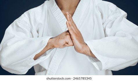 Man, hands and karate form in studio, fighter and ready for training or practice on dark background. Male person, athlete and warrior in dojo for martial arts, respect gesture and welcome to sports - Powered by Shutterstock