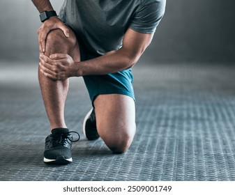 Man, hands and knee pain with injury in muscle tension, accident or fitness on floor at gym. Closeup of male person with sore leg, ache or inflammation in strain, pressure or sprain at health club