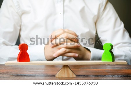 A man with hands in the lock and looks at the scales with green and red figures. conflict resolution and search for a compromise. Disagreement and misunderstanding, establishing contact. Agreements