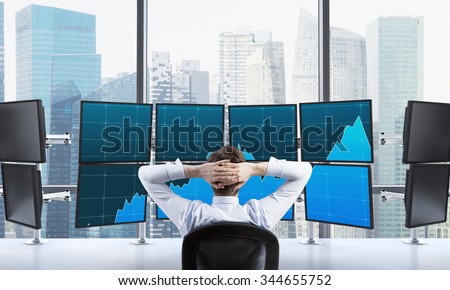 man with hands locked on back of the head sitting in front of monitors, processing data for trading, singapore at the background