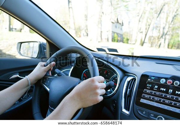 Man with hands on\
driving wheel in car