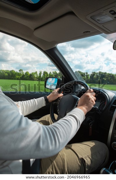 man\
hands on steering wheel cloudy sunny day copy\
space