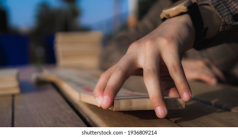 Man Hands Playing Giant Domino On A Table