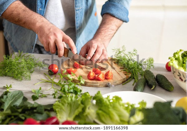 Man hands prepares food on cutting board. Healthy\
food concept
