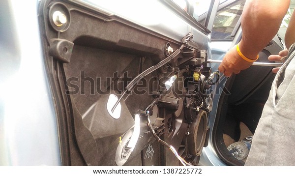 A man\
hands repair left door Car locks repair\
man.