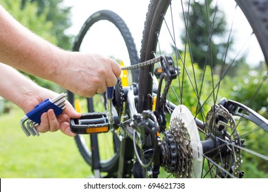 Man Hands Repairing The Bike By Repair Key, Doing Maintenance Of Bicycle